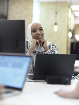 african muslim businesswoman portrait  wearing hijab at creative modern startup coworking open space office