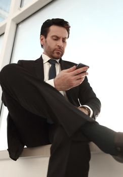 businessman typing SMS on his smartphone. business and technology