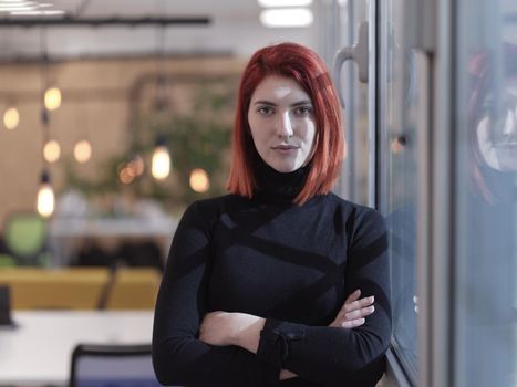 redhead business woman portrait as influencer in creative modern coworking startup open space office