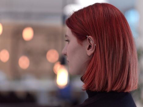 redhead business woman portrait as influencer in creative modern coworking startup open space office