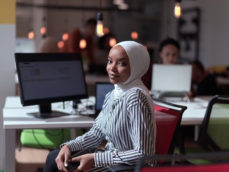 african muslim businesswoman portrait wearing hijab at creative modern startup coworking open space office