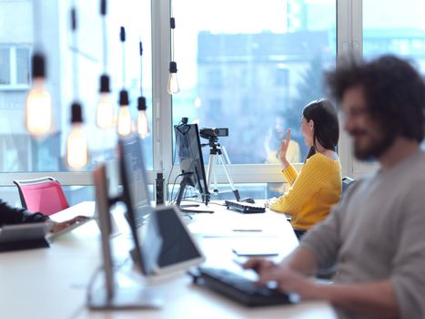 business woman have online meeting in modern open space coworking office as influencer making podcat or tutorial videos