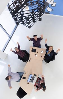 top view of multi ethnic startup business people group on brainstorming meeting in modern bright office interior
