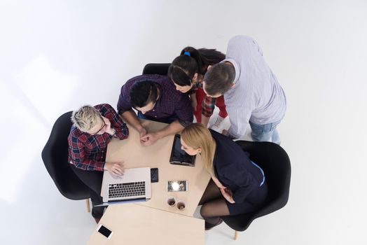 top view of multi ethnic startup business people group on brainstorming meeting in modern bright office interior