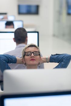 startup business, woman  working on dektop  computer at creative modern office relaxing and have fun