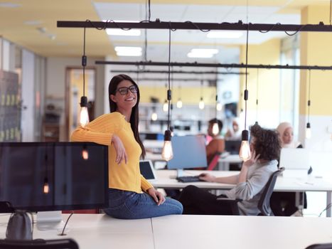 business woman portrait in open space startup coworking open space office as influencer using smart phone, tablet computer