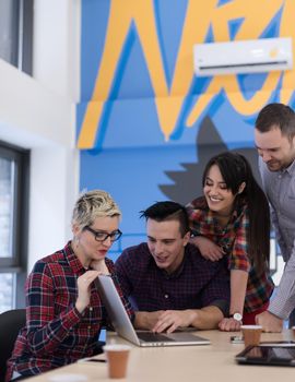 startup business team on meeting in modern bright office interior brainstorming, working on laptop and tablet computer