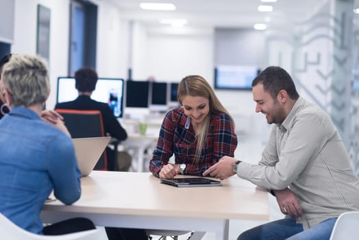 startup business team on meeting in modern bright office interior brainstorming, working on laptop and tablet computer