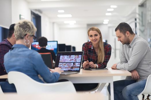 startup business team on meeting in modern bright office interior brainstorming, working on laptop and tablet computer