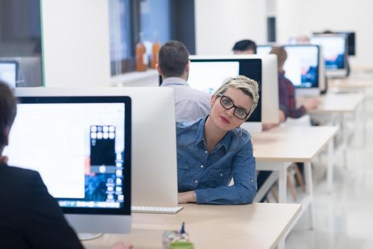 startup business, woman  working on dektop  computer at creative modern office relaxing and have fun