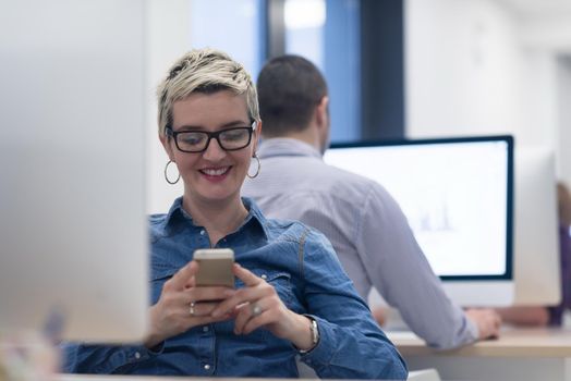 startup business, woman  working on dektop  computer at creative modern office relaxing and have fun