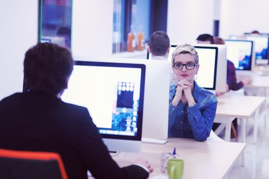 startup business, woman  working on dektop  computer at creative modern office relaxing and have fun