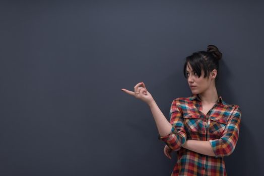 portrait of young startup business woman at modern office, grey chalkboard wall in background