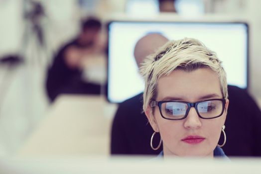 startup business, woman  working on dektop  computer at creative modern office relaxing and have fun