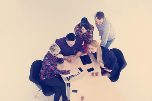 top view of multi ethnic startup business people group on brainstorming meeting in modern bright office interior