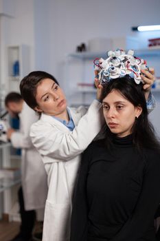 Researcher engineer woman putting eeg scanner on woman patient head during neurology experiment in medical laboratory. Neurologist doctor analyzing brain evolution monitoring nervous system activity