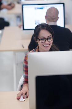 startup business, woman  working on dektop  computer at creative modern office relaxing and have fun