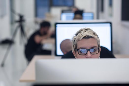 startup business, woman  working on dektop  computer at creative modern office relaxing and have fun