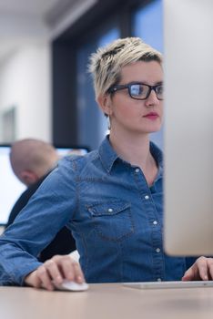 startup business, woman  working on dektop  computer at creative modern office relaxing and have fun