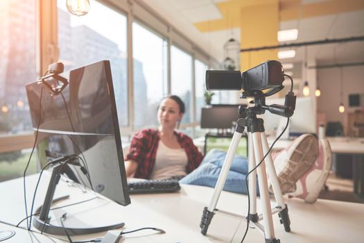 online education elearning concept with young student or businesswoman at office filming with camera from tripod