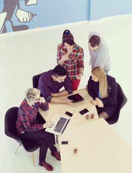 top view of multi ethnic startup business people group on brainstorming meeting in modern bright office interior