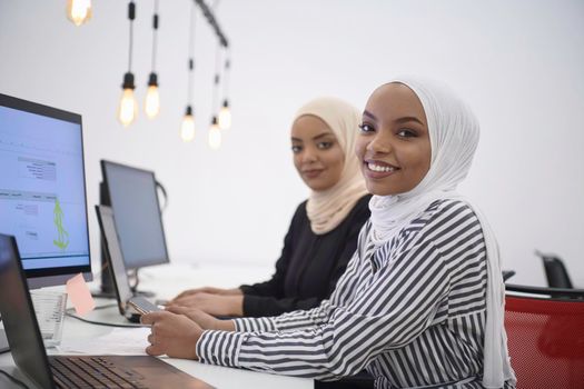 beautiful modern african Muslim businesswoman in office, wearing hijab at creative modern startup coworking space