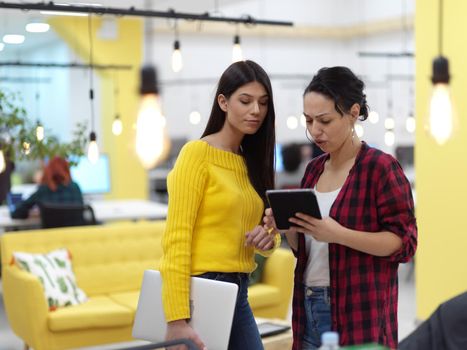 group of female friends having a team meeting and discussion about project or in modern startup business open space coworking office