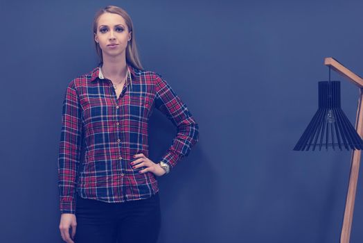 portrait of young startup business woman at modern office, grey chalkboard wall in background