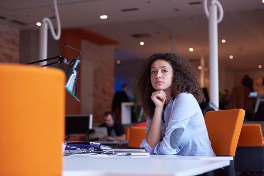 happy young  business woman with curly hairstyle in the modern office