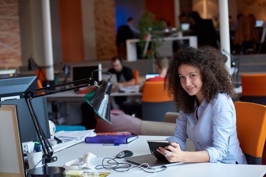 happy young  business woman with curly hairstyle in the modern office