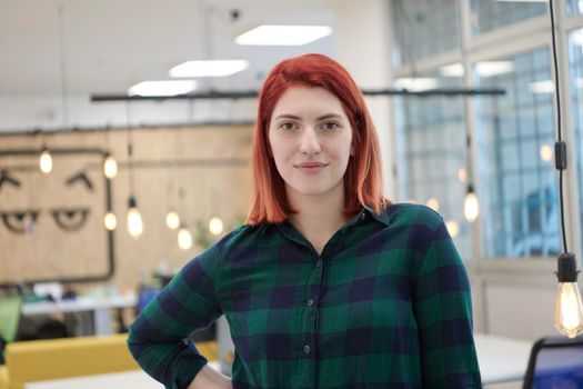 redhead business woman portrait  in creative modern coworking startup open space office