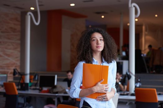 happy young  business woman with curly hairstyle in the modern office