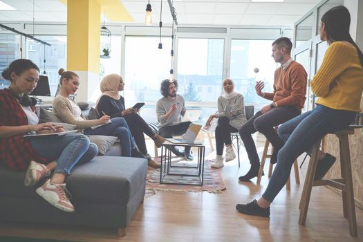 business people group in modern office have a team meeting and brainstorming while working on tablet or laptop  presenting ideas and take notes