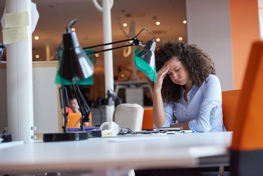 happy young  business woman with curly hairstyle in the modern office