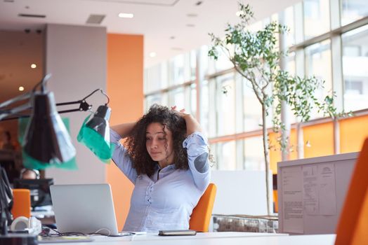 happy young  business woman with curly hairstyle in the modern office