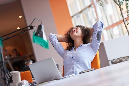 happy young  business woman with curly hairstyle in the modern office