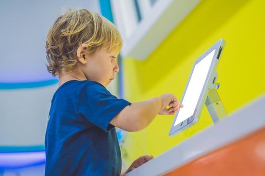 Boy playing with digital tablet. Children and technology concept.