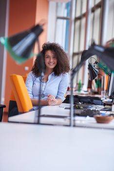 happy young  business woman with curly hairstyle in the modern office