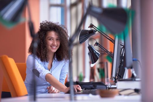 happy young  business woman with curly hairstyle in the modern office