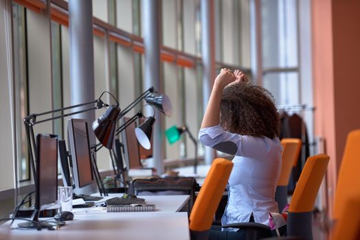 happy young  business woman with curly hairstyle in the modern office