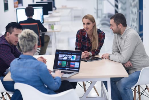 startup business team on meeting in modern bright office interior brainstorming, working on laptop and tablet computer