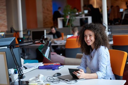 happy young  business woman with curly hairstyle in the modern office