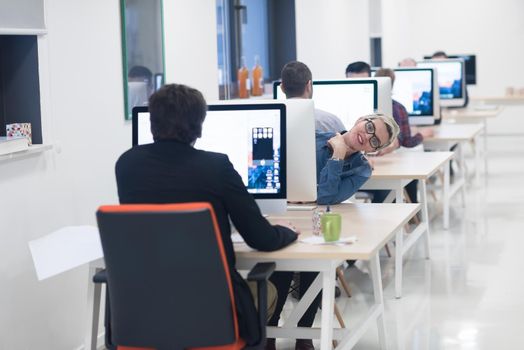 startup business, woman  working on dektop  computer at creative modern office relaxing and have fun