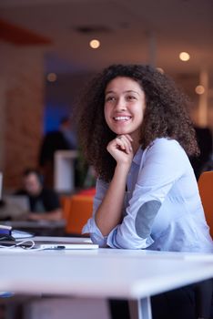 happy young  business woman with curly hairstyle in the modern office