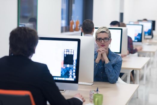 startup business, woman  working on dektop  computer at creative modern office relaxing and have fun