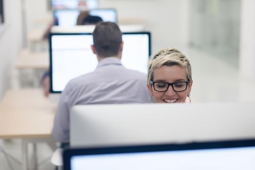 startup business, woman  working on dektop  computer at creative modern office relaxing and have fun