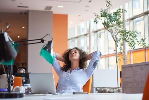 happy young  business woman with curly hairstyle in the modern office