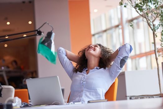 happy young  business woman with curly hairstyle in the modern office