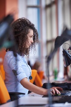 happy young  business woman with curly hairstyle in the modern office