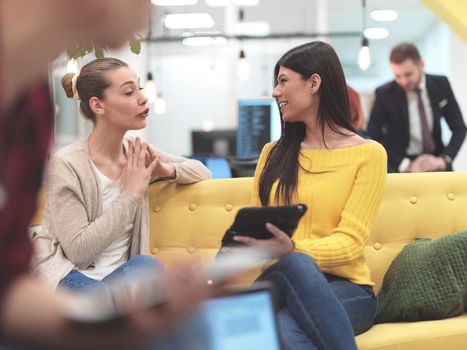 group of female friends having a team meeting and discussion about project or gossip chatting in modern startup business  open space coworking office